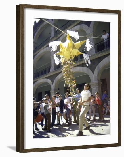 Children Taking Turns Breaking Pinata During Christmas Festival-John Dominis-Framed Photographic Print