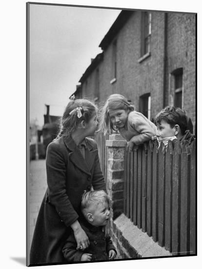 Children Talking over Fence on Queen Caroline St-Nat Farbman-Mounted Photographic Print