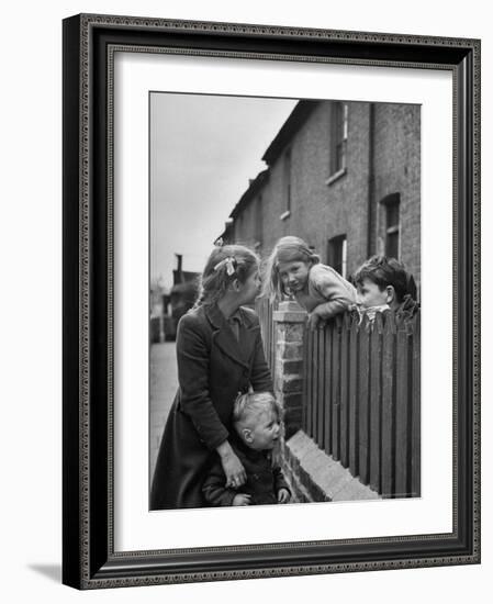 Children Talking over Fence on Queen Caroline St-Nat Farbman-Framed Photographic Print