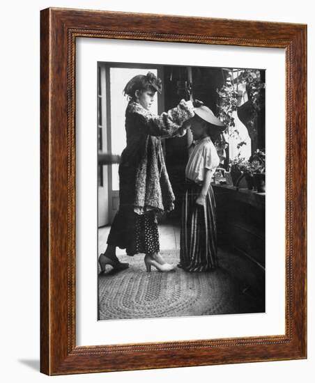 Children Trying on Old Clothes in the Attic, but Little Boy Would Prefer to Be Playing Football-Gordon Parks-Framed Photographic Print