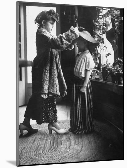 Children Trying on Old Clothes in the Attic, but Little Boy Would Prefer to Be Playing Football-Gordon Parks-Mounted Photographic Print