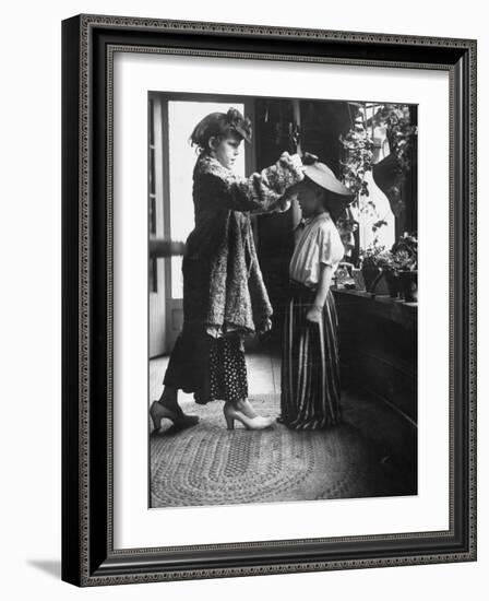 Children Trying on Old Clothes in the Attic, but Little Boy Would Prefer to Be Playing Football-Gordon Parks-Framed Photographic Print