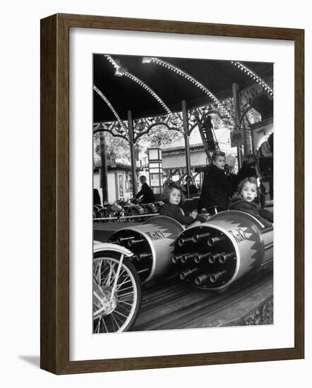 Children Waiting Expectantly For a "Rocket Ride" on the Carousel-Nina Leen-Framed Photographic Print