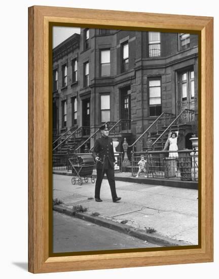 Children Watching a Policeman Walk His Beat in Front of Apartment Buildings-Ed Clark-Framed Premier Image Canvas