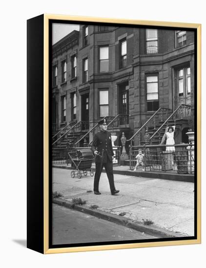Children Watching a Policeman Walk His Beat in Front of Apartment Buildings-Ed Clark-Framed Premier Image Canvas