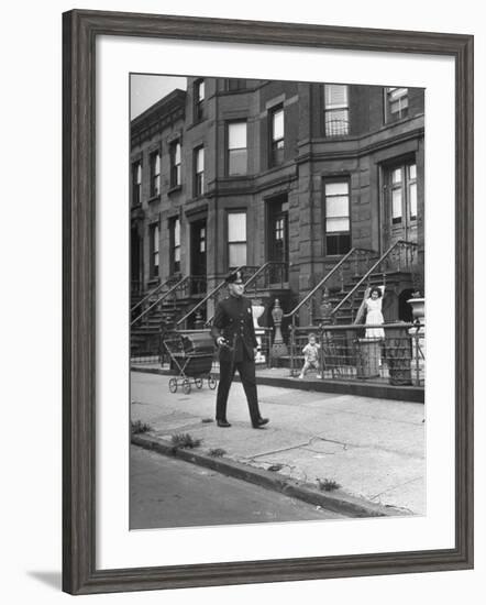 Children Watching a Policeman Walk His Beat in Front of Apartment Buildings-Ed Clark-Framed Photographic Print