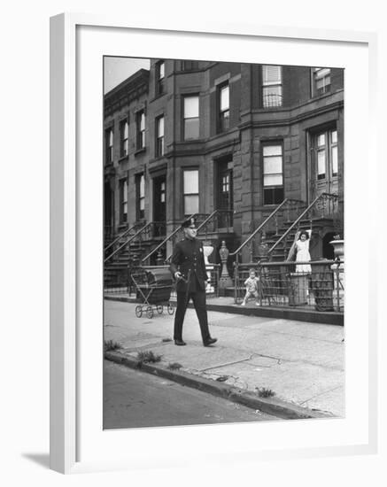 Children Watching a Policeman Walk His Beat in Front of Apartment Buildings-Ed Clark-Framed Photographic Print