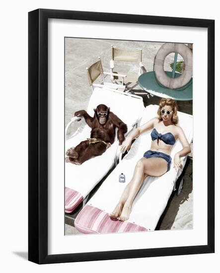 Chimpanzee and a Woman Sunbathing--Framed Photo