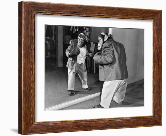 Chimpanzee in a Jacket and Trousers in Front of a Mirror-null-Framed Photo