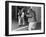 Chimpanzee in a Jacket and Trousers in Front of a Mirror-null-Framed Photo