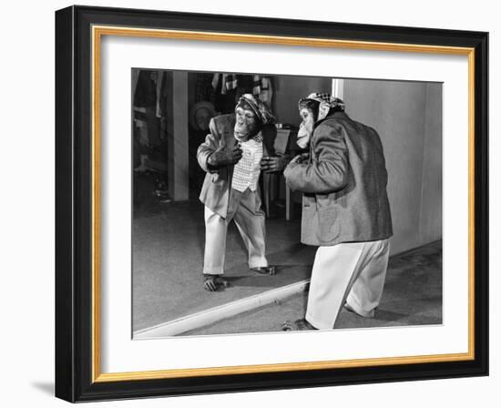 Chimpanzee in a Jacket and Trousers in Front of a Mirror-null-Framed Photo