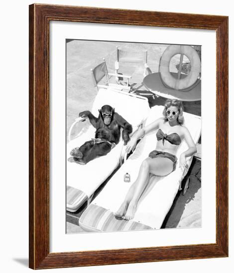 Chimpanzee & Woman Sunbathing-null-Framed Art Print