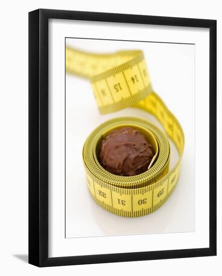 Chocolate Truffle Lying in Rolled-Up Tape Measure-Elisabeth Cölfen-Framed Photographic Print