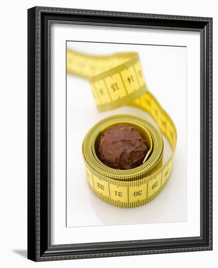 Chocolate Truffle Lying in Rolled-Up Tape Measure-Elisabeth Cölfen-Framed Photographic Print