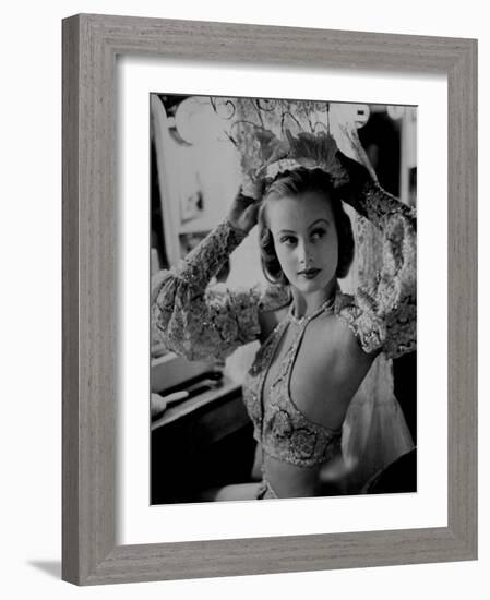 Chorus Girl Hope Chandler Securing Her Feathered Headdress as She Sits at Makeup Table-Peter Stackpole-Framed Photographic Print