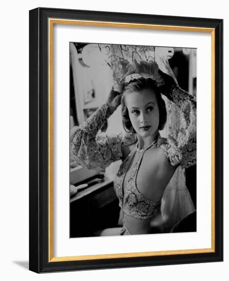 Chorus Girl Hope Chandler Securing Her Feathered Headdress as She Sits at Makeup Table-Peter Stackpole-Framed Photographic Print