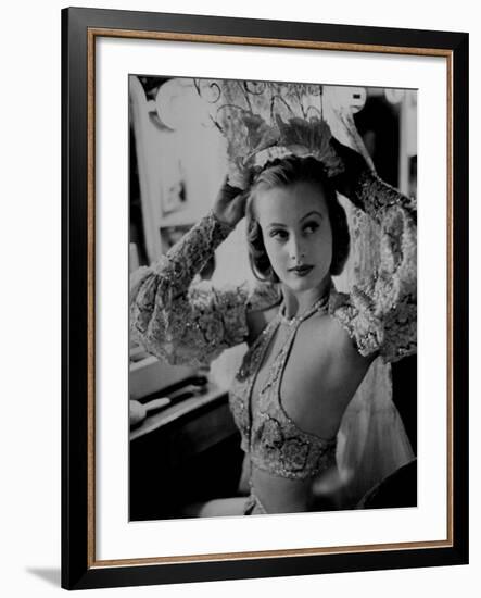 Chorus Girl Hope Chandler Securing Her Feathered Headdress as She Sits at Makeup Table-Peter Stackpole-Framed Photographic Print