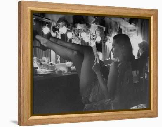 Chorus Girl-Singer Linda Lombard, Resting Her Legs after a Tough Night on Stage-George Silk-Framed Premier Image Canvas