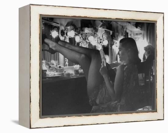 Chorus Girl-Singer Linda Lombard, Resting Her Legs after a Tough Night on Stage-George Silk-Framed Premier Image Canvas