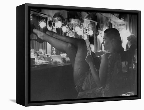 Chorus Girl-Singer Linda Lombard, Resting Her Legs after a Tough Night on Stage-George Silk-Framed Premier Image Canvas
