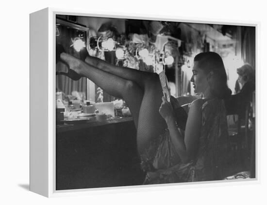 Chorus Girl-Singer Linda Lombard, Resting Her Legs after a Tough Night on Stage-George Silk-Framed Premier Image Canvas