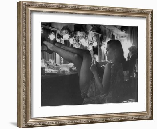 Chorus Girl-Singer Linda Lombard, Resting Her Legs after a Tough Night on Stage-George Silk-Framed Photographic Print