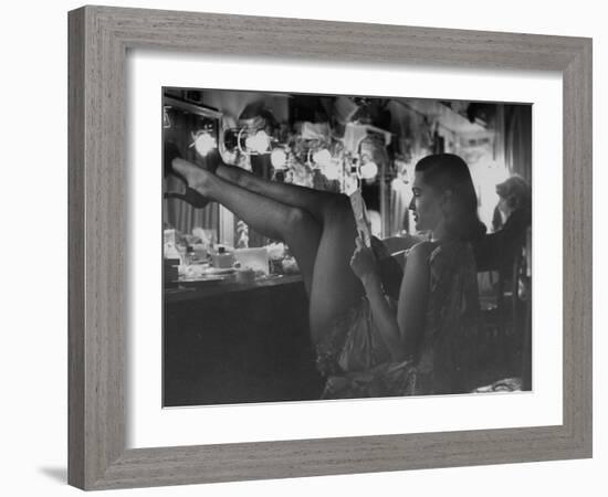 Chorus Girl-Singer Linda Lombard, Resting Her Legs after a Tough Night on Stage-George Silk-Framed Photographic Print