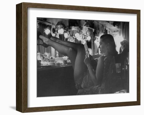 Chorus Girl-Singer Linda Lombard, Resting Her Legs after a Tough Night on Stage-George Silk-Framed Photographic Print