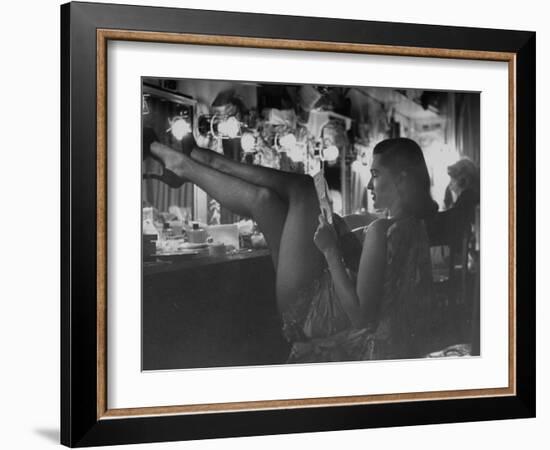 Chorus Girl-Singer Linda Lombard, Resting Her Legs after a Tough Night on Stage-George Silk-Framed Photographic Print