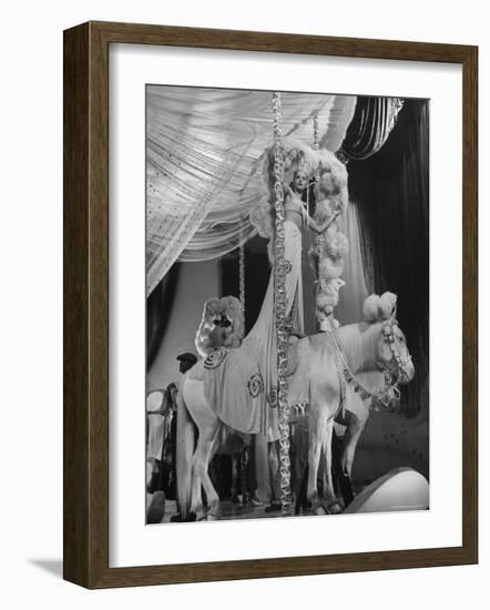 Chorus Girl Standing on Horse's Back During Filming of the Movie "The Ziegfeld Follies"-John Florea-Framed Photographic Print