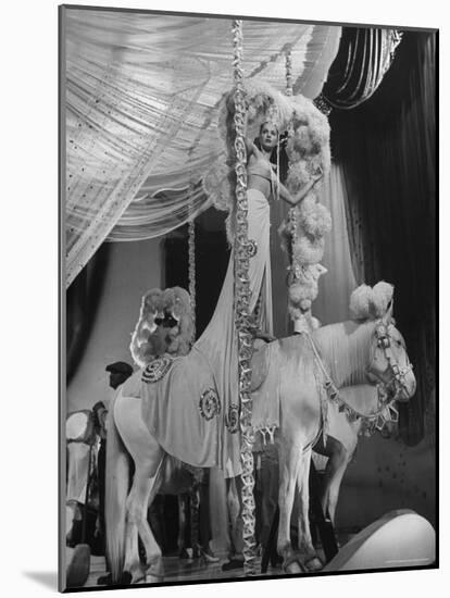 Chorus Girl Standing on Horse's Back During Filming of the Movie "The Ziegfeld Follies"-John Florea-Mounted Photographic Print