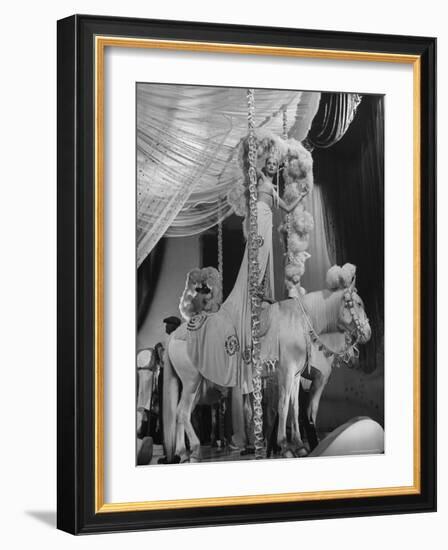 Chorus Girl Standing on Horse's Back During Filming of the Movie "The Ziegfeld Follies"-John Florea-Framed Photographic Print