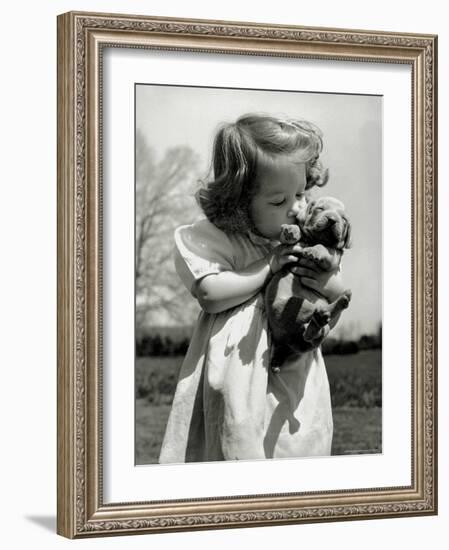 Christina Goldsmith Kissing a Weimaraner Puppy from Her Father's Stock of Weimaraner Hunting Dogs-Bernard Hoffman-Framed Photographic Print