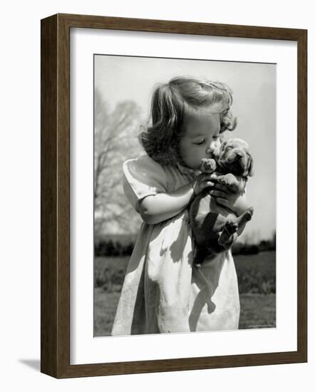 Christina Goldsmith Kissing a Weimaraner Puppy from Her Father's Stock of Weimaraner Hunting Dogs-Bernard Hoffman-Framed Photographic Print