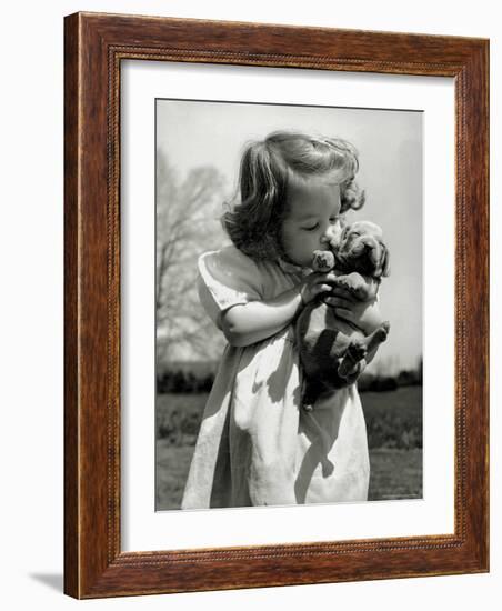 Christina Goldsmith Kissing a Weimaraner Puppy from Her Father's Stock of Weimaraner Hunting Dogs-Bernard Hoffman-Framed Photographic Print