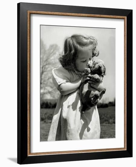 Christina Goldsmith Kissing a Weimaraner Puppy from Her Father's Stock of Weimaraner Hunting Dogs-Bernard Hoffman-Framed Photographic Print