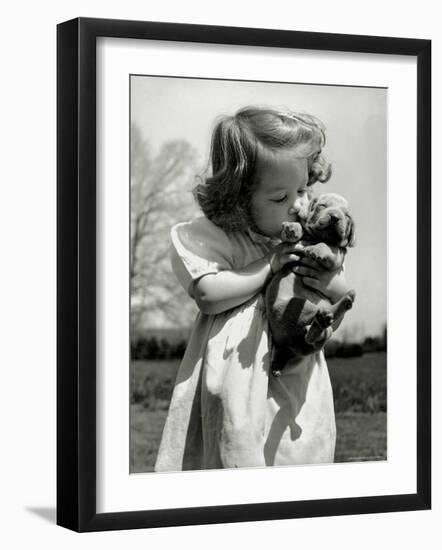 Christina Goldsmith Kissing a Weimaraner Puppy from Her Father's Stock of Weimaraner Hunting Dogs-Bernard Hoffman-Framed Photographic Print