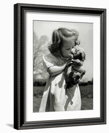 Christina Goldsmith Kissing a Weimaraner Puppy from Her Father's Stock of Weimaraner Hunting Dogs-Bernard Hoffman-Framed Photographic Print