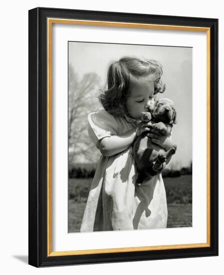 Christina Goldsmith Kissing a Weimaraner Puppy from Her Father's Stock of Weimaraner Hunting Dogs-Bernard Hoffman-Framed Photographic Print