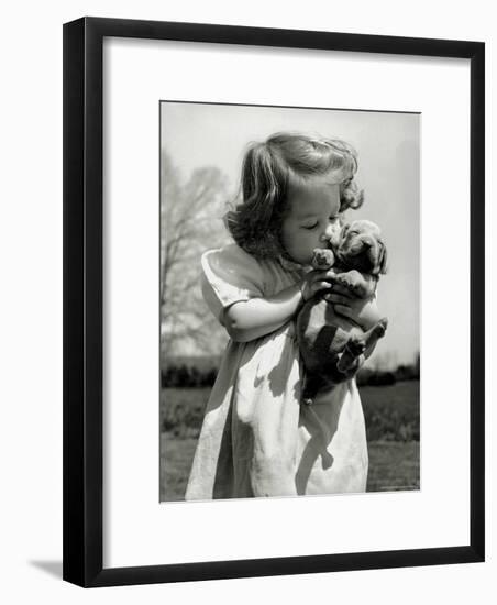 Christina Goldsmith Kissing a Weimaraner Puppy from Her Father's Stock of Weimaraner Hunting Dogs-Bernard Hoffman-Framed Photographic Print