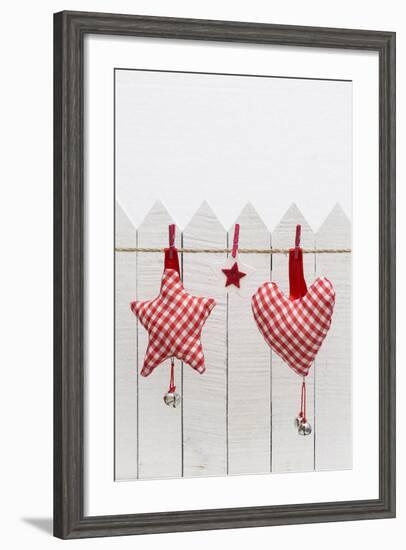 Christmas Ornament Hanging in Front of White Wooden Fence-Andrea Haase-Framed Photographic Print