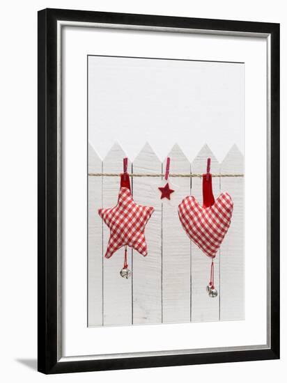 Christmas Ornament Hanging in Front of White Wooden Fence-Andrea Haase-Framed Photographic Print