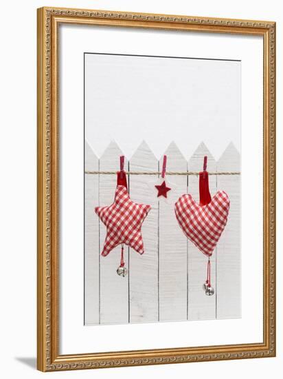 Christmas Ornament Hanging in Front of White Wooden Fence-Andrea Haase-Framed Photographic Print