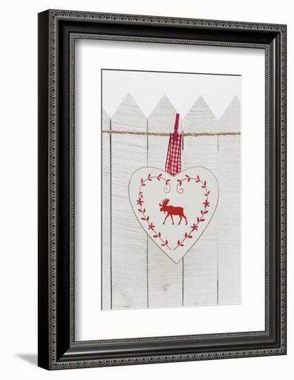 Christmas Ornament Hanging in Front of White Wooden Fence-Andrea Haase-Framed Photographic Print