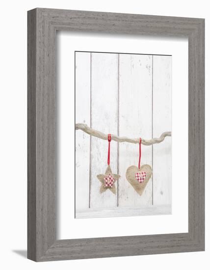 Christmas Ornaments Hanging in Front of White Wood-Andrea Haase-Framed Photographic Print