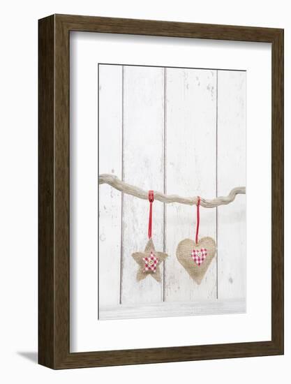 Christmas Ornaments Hanging in Front of White Wood-Andrea Haase-Framed Photographic Print
