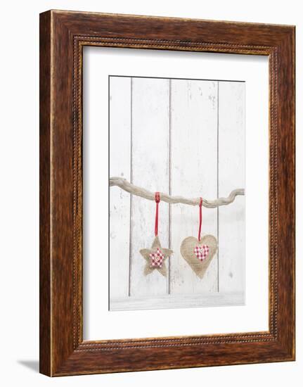 Christmas Ornaments Hanging in Front of White Wood-Andrea Haase-Framed Photographic Print