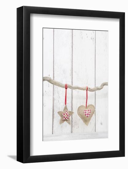 Christmas Ornaments Hanging in Front of White Wood-Andrea Haase-Framed Photographic Print