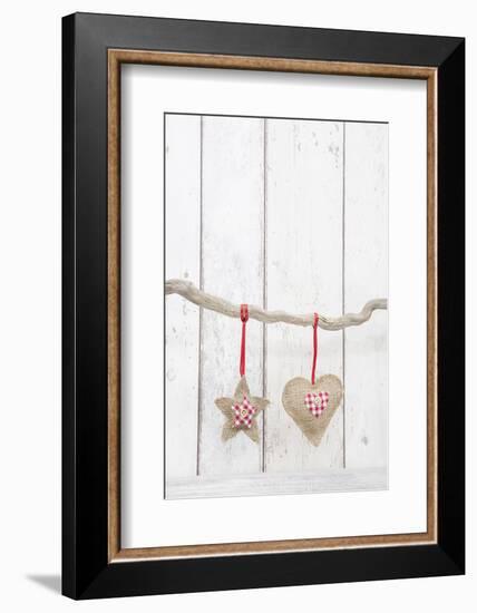 Christmas Ornaments Hanging in Front of White Wood-Andrea Haase-Framed Photographic Print
