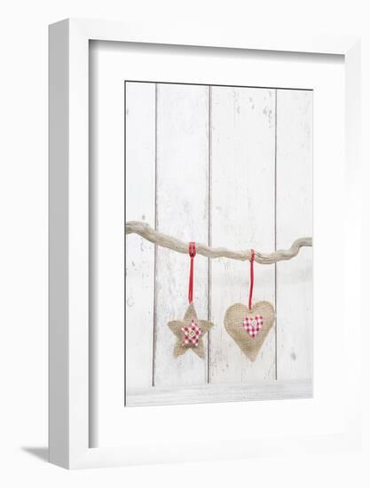 Christmas Ornaments Hanging in Front of White Wood-Andrea Haase-Framed Photographic Print